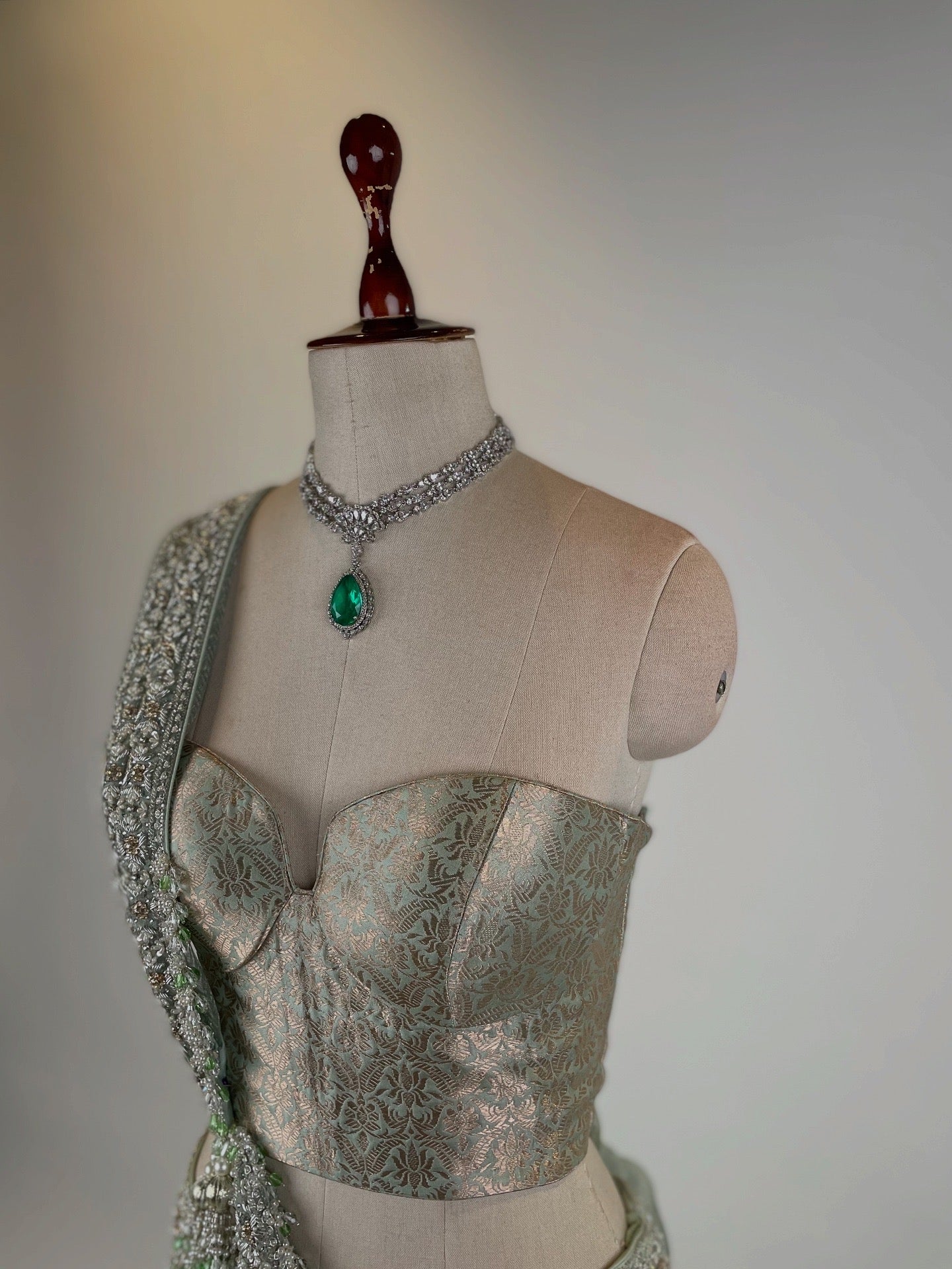 MINT GREEN KOTA TISSUE LEHENGA EMBELLISHED WITH CRYSTALS AND ZARDOZI PAIRED WITH BANARASI CORSET BLOUSE