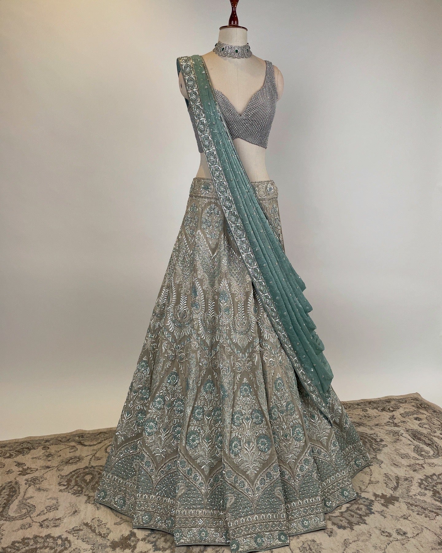 SILVER LEHENGA WITH ZARDOZI & FRENCH KNOT WORK PAIRED WITH SILVER RHINESTONE EMBELLISHED BLOUSE AND BLUE DUPATTA