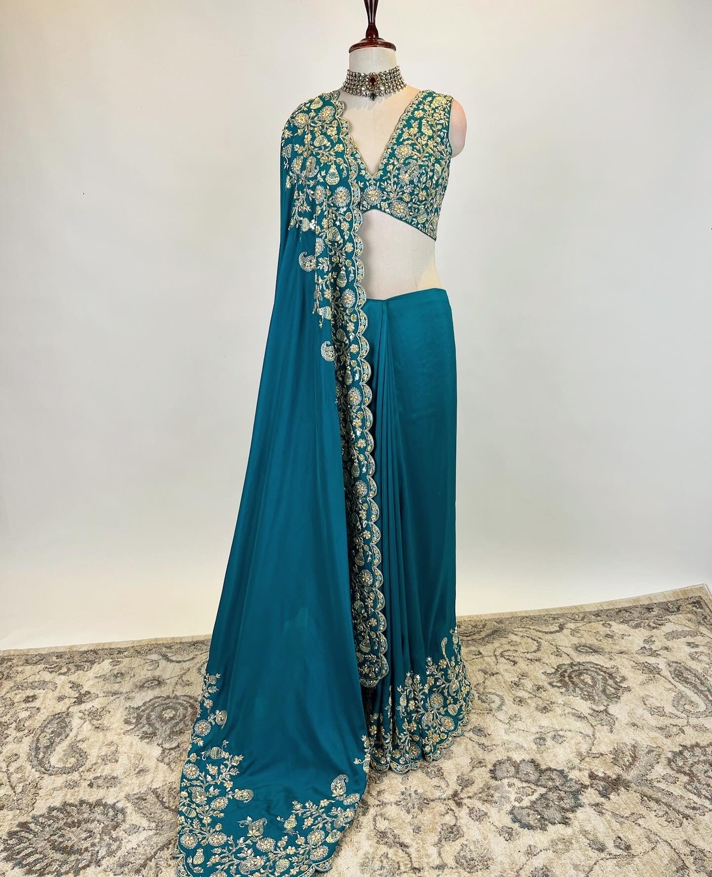 Teal Zardosi Saree in Crepe Silk with an embroidered sleeveless blouse