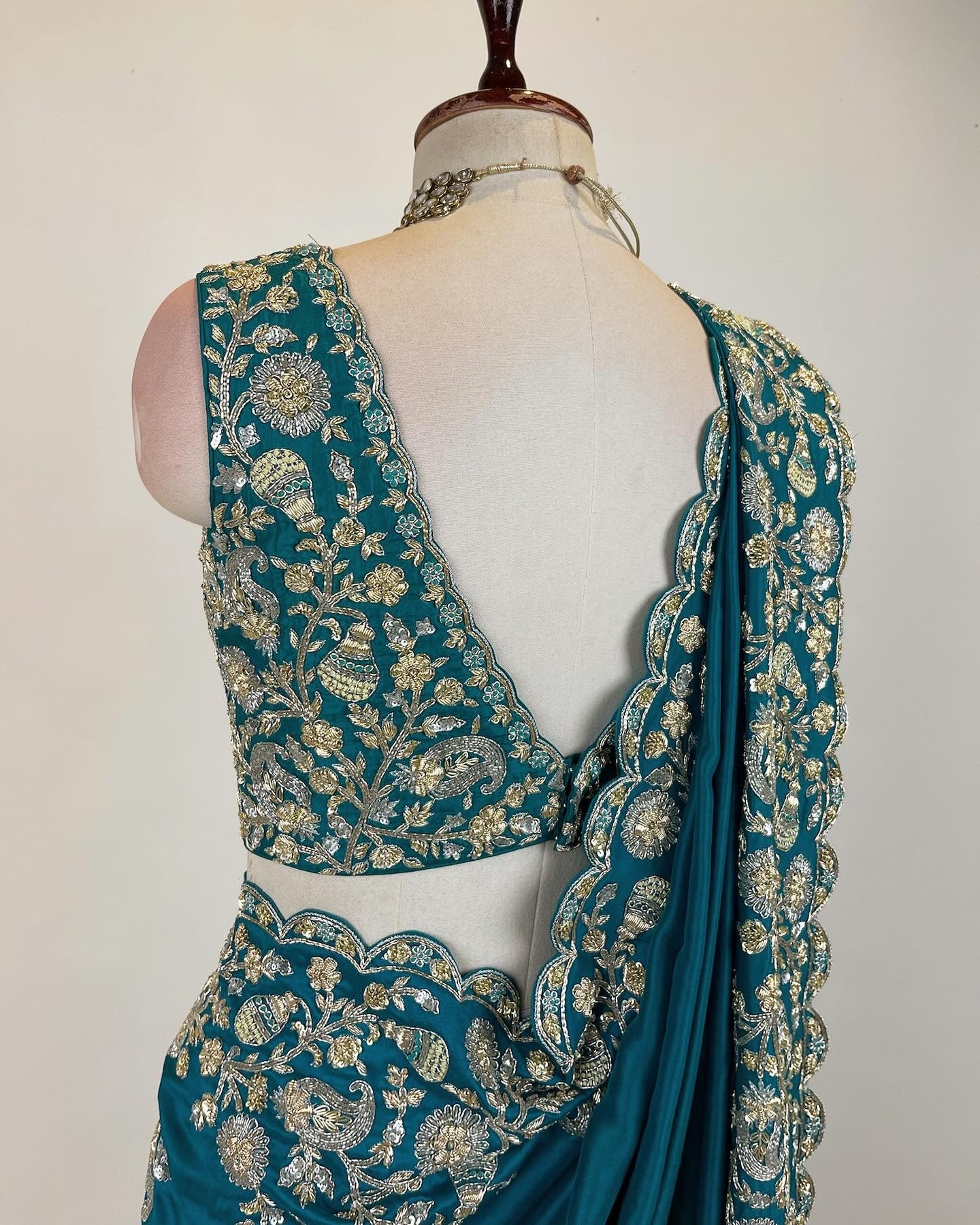 Teal Zardosi Saree in Crepe Silk with an embroidered sleeveless blouse