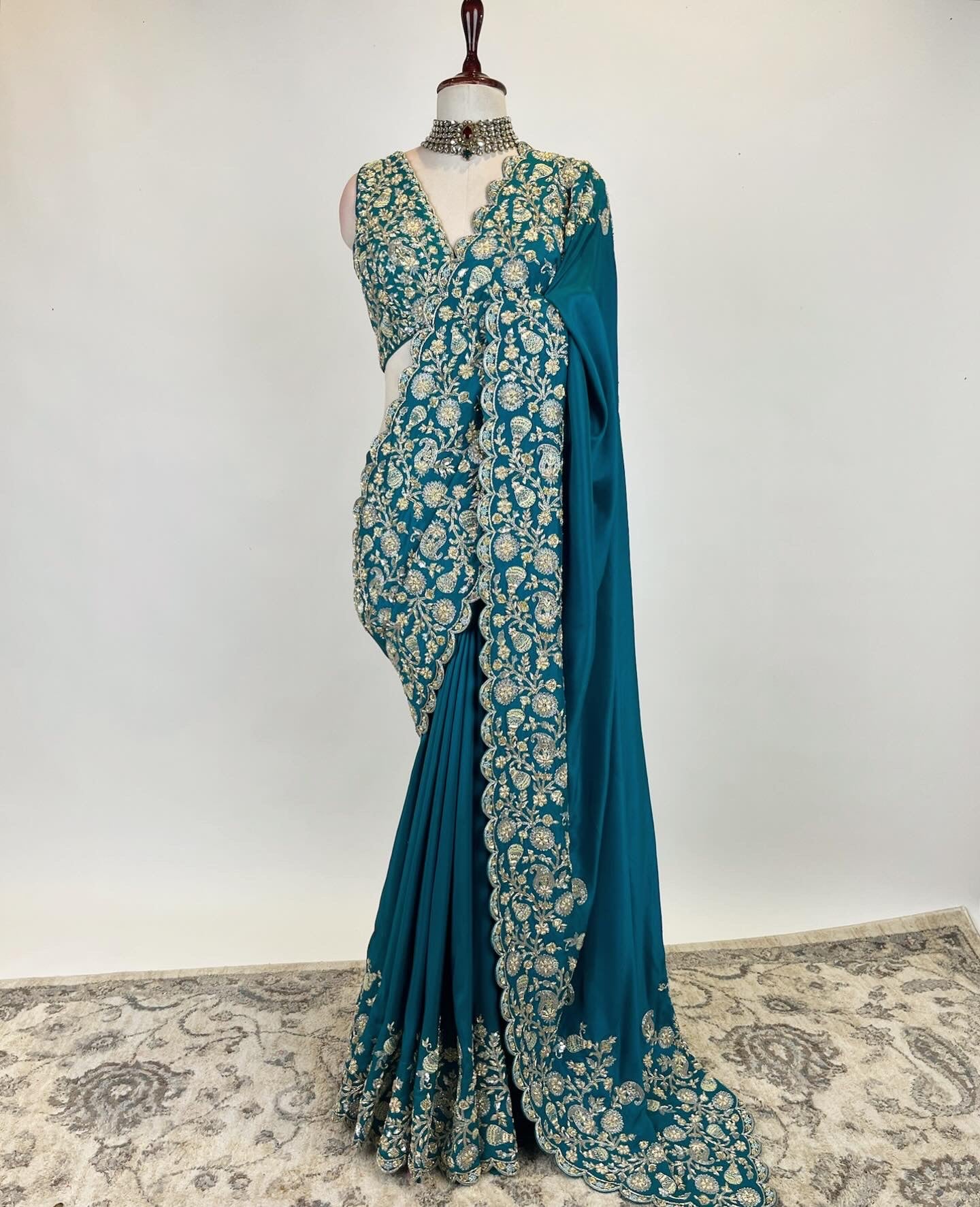 Teal Zardosi Saree in Crepe Silk with an embroidered sleeveless blouse