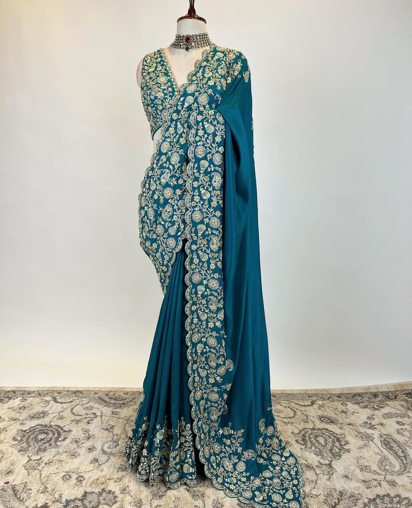 Teal Zardosi Saree in Crepe Silk with an embroidered sleeveless blouse