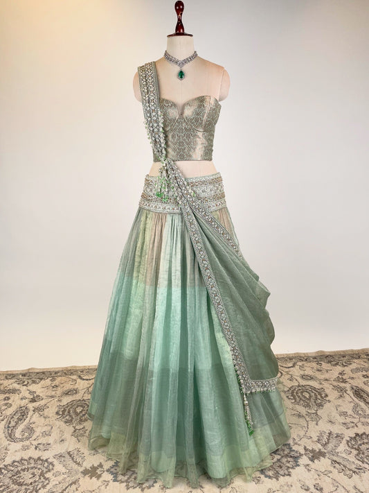 MINT GREEN KOTA TISSUE LEHENGA EMBELLISHED WITH CRYSTALS AND ZARDOZI PAIRED WITH BANARASI CORSET BLOUSE