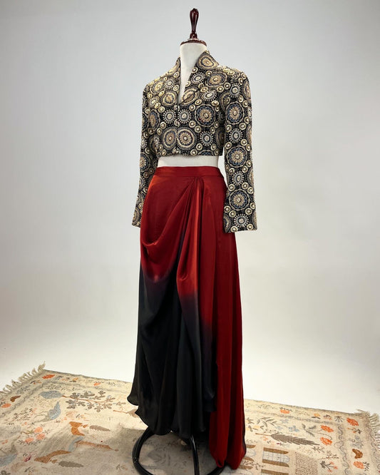 AJRAKH SHORT JACKET STUDDED WITH SEQUIN, PEARLS, ZARI & STONES PAIRED WITH PRE- DRAPED SKIRT