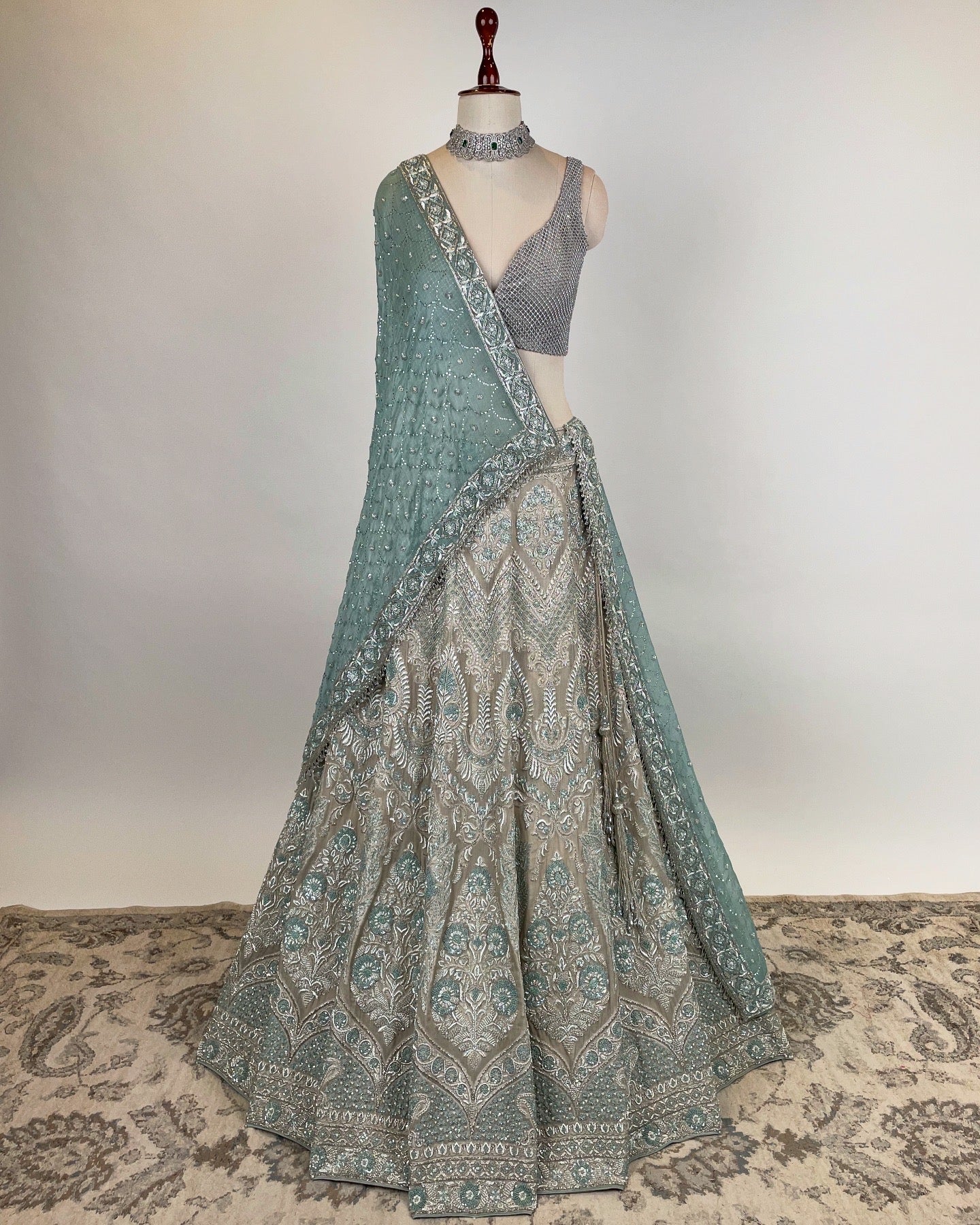 SILVER LEHENGA WITH ZARDOZI & FRENCH KNOT WORK PAIRED WITH SILVER RHINESTONE EMBELLISHED BLOUSE AND BLUE DUPATTA