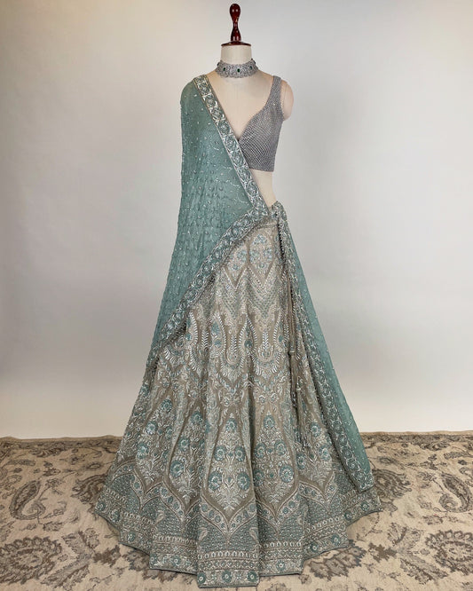 SILVER LEHENGA WITH ZARDOZI & FRENCH KNOT WORK PAIRED WITH SILVER RHINESTONE EMBELLISHED BLOUSE AND BLUE DUPATTA