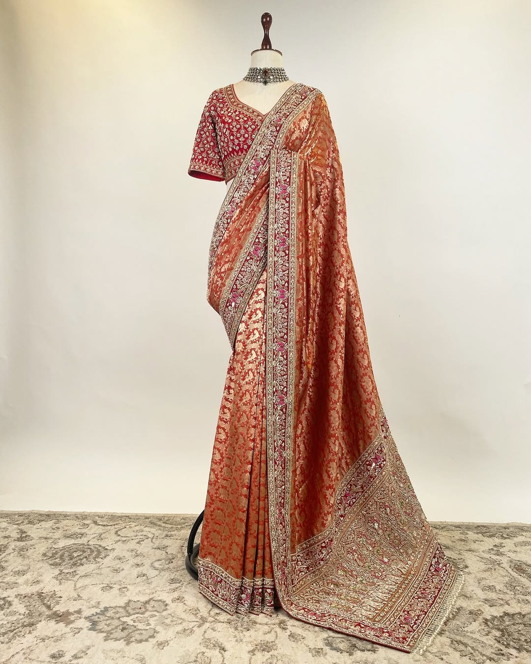 RUST ORANGE BROCADE ZARI SAREE WITH ZARDOSI FRENCH KNOT AND PEARLS AND RED EMBROIDERED BLOUSE