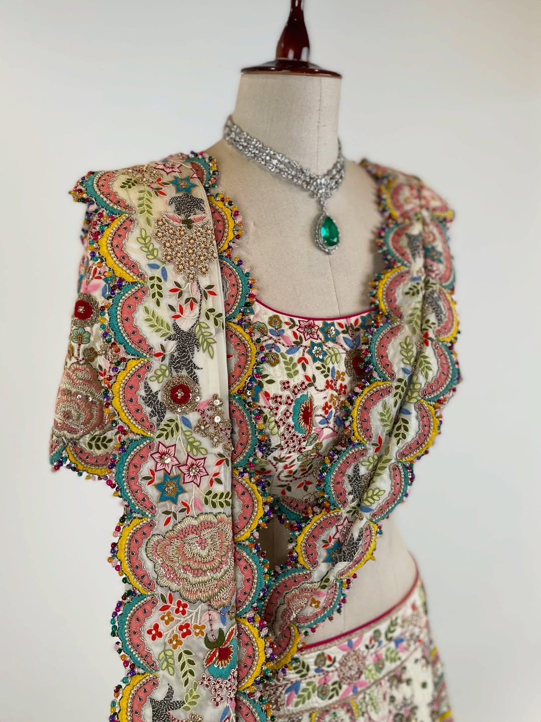 BEIGE RESHAM AND DORI HAND-EMBROIDERED LEHENGA EMBELLISHED WITH MULTI-COLOURED PEARLS